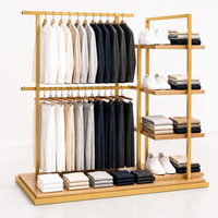 Présentoir îlot double barre en métal noir pour vêtements avec étagères latérales à chaussures et base en bois – Vente en gros