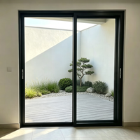 Porte patio coulissante à deux panneaux, cadre noir mat, verre transparent, poignée encastrée, jardin zen, aluminium