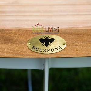 The Cattalina <b>Round</b> <b>Table</b> has a sturdy base made of iron and aluminum, with a <b>top</b> made of high-quality teak <b>wood</b> - Product Image 3