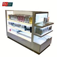 Kiosque de présentation de parfums moderne blanc pliable et rotatif avec étagères en métal et en verre