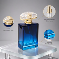 Flacon de parfum bleu dégradé en gros 50ml 1.7oz, base en verre épais, col doré brillant, bouchon arqué, emballage personnalisé