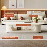 Table basse ovale blanc crème, base de rangement ouverte creuse, style minimaliste, profil bas, pour salon, table à thé