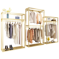 Portant à vêtements robuste en métal doré brillant en acier inoxydable pour boutique de vêtements sur mesure