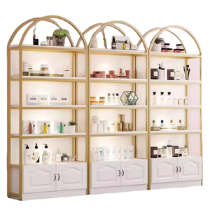 Étagère de présentation cosmétique de luxe avec cadre doré, présentoir autoportant arqué avec <span class=keywords><strong>armoire</strong></span> de rangement pour les boutiques de beauté - Product Image 3
