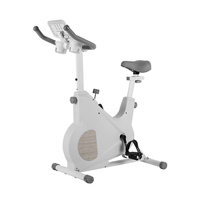 Vélo d'exercice à domicile blanc avec transmission par courroie magnétique, support pour tablette et porte-gobelet pour un entraînement cardio confortable en intérieur