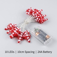 Guirlande lumineuse LED blanc chaud avec ornement en forme de nœud rouge et canne à sucre, câble transparent, fonctionne à piles, pour décoration de Noël