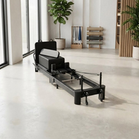 Lit de Pilates Reformer pliable en aluminium noir de marque Tmax, machines de Pilates Reformer pliantes avec pieds réglables pour exercices de renforcement du tronc