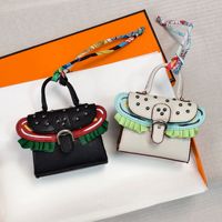 Porte-monnaie miniature de luxe style dessin animé mignon, porte-clés en cuir PU écologique, breloques ovales avec ruban de soie coloré