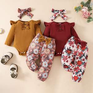 Ensemble trois pièces pour bébé en coton transfrontalier : haut à manches longues en dentelle, pantalon triangle à fleurs et nœud, ceinture pour cheveux - Product Image 1