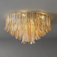 Plafonnier en verre Plume, hauteur réglable, longue suspension ronde en fer doré