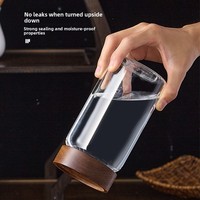 Vente en gros de récipient de stockage des aliments en verre borosilicaté à haute teneur en borosilicate cylindre de bocal transparent avec couvercle en acacia