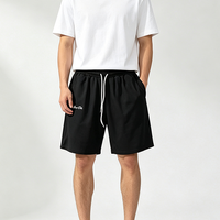 Shorts en tricot gaufré pour hommes, taille élastique, cordon de serrage contrastant blanc, poches latérales, coupe ample, longueur genou, style streetwear