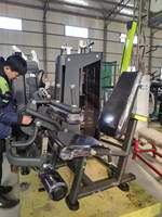 Machine de musculation à double fonction (extension et curl des jambes) à charge par broches, conception originale MND, en vente directe d'usine