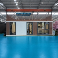 Maison conteneur préfabriquée surélevée et élargie de 30 pieds avec revêtement en panneaux sandwich d'acier pour studio de jardin et atelier