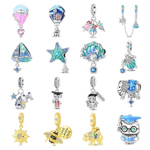 Une collection de bracelets et pendentifs en laiton blanc ornés de motifs en émail coloré - Product Image 1