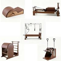 Ensemble de cinq pièces de Pilates en noyer massif : Cadillac, Reformer, Wunda Chair, Ladder Barrel, Spine Corrector