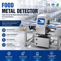 Machine automatique de détection des métaux dans les aliments. avec commande par écran tactile et système de rejet par poussoir pour ligne d'emballage