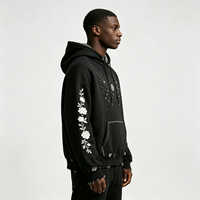 Sweat-shirt à capuche noir avec broderie florale sur les manches, panneau étoile en strass, ourlet déchiré, poche kangourou, style streetwear