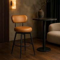 Chaise de bar pivotante en cuir caramel avec dossier incurvé, coussin rond rembourré, pieds noirs et anneau repose-pieds, idéale pour café