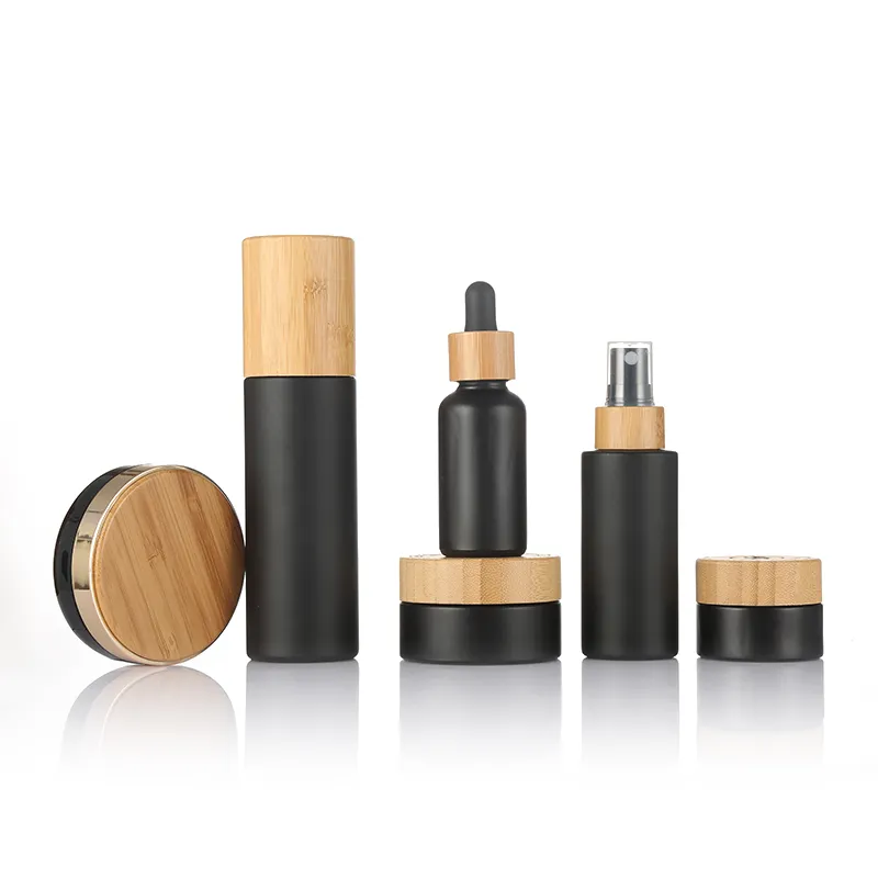 Boş cam kozmetik ambalaj setleri mat siyah krem kavanoz bambu ahşap kapak cam şişe için toner losyon