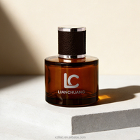 Flacon de parfum en verre vide de luxe, cylindrique et court, avec logo personnalisé, capuchon cylindrique enveloppé de cuir et boîte.