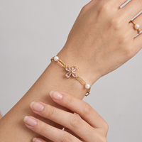 Bracelet de luxe européen en acier inoxydable avec chaîne trombone, orné d'une fleur à quatre pétales, de cristaux et de perles d'eau douce, idéal pour le quotidien et le bureau