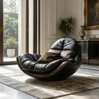 Fauteuil de loisirs individuel en cuir noir avec cadre en fibre de verre noir, coussin moelleux, idéal pour les espaces de vie modernes aux tons sombres