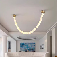 Lustre moderne de luxe en albâtre avec pendentif LED en forme de boule de perles, idéal pour chambre, hôtel et décoration intérieure