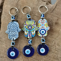 Cadeau tendance : Porte-monnaie porte-bonheur turc en alliage de zinc avec œil bleu et main de Hamsa - Pendentif pour sac/voiture/décoration intérieure
