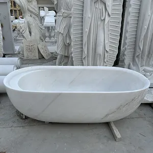 Pasokan langsung pabrik rumah dalam ruangan ukiran tangan bak mandi marmer putih alami berdiri bebas