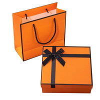 Boîte de papier orange de luxe conception de ruban matériaux recyclés boîte-cadeau de Noël décorative vide pour l'emballage de vêtements gaufrage