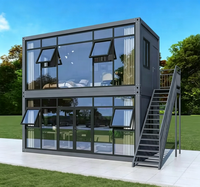 Maison conteneur préfabriquée modulaire en acier de 20 pieds avec mur rideau en verre pour bureau, studio, jardin, extérieur