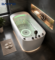 Baignoire de massage à remous en acrylique, vente directe usine, avec panneau latéral en verre, robinet cascade et éclairage LED, idéale pour hôtels et villas