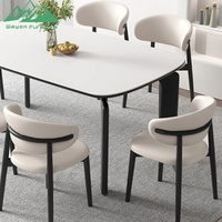 Ensemble de table à manger Wayon moderne avec plateau en marbre blanc, pieds architecturaux noirs, chaises rembourrées