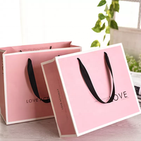 Sacs en papier à poignée en ruban pour emballage, sacs cadeaux de luxe personnalisés avec logo pour boutique de cosmétiques et vêtements, couleur rose