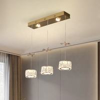 Lustre suspendu moderne de luxe en acier inoxydable avec plusieurs têtes cylindriques, fleurs en cristal doré, pour bar et salle à manger