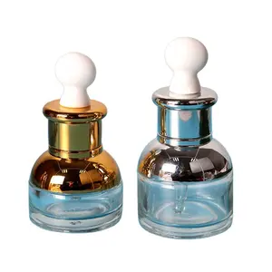 Personalizado claro 30ml de vidrio de 1oz líquido cosmético botellas de suero con oro y plata UV cuentagotas en stock