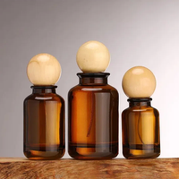 Vente en gros Flacons de parfum en verre ambré de luxe ronds de 30ml 50ml 100ml Flacon diffuseur en verre avec boule à bouchon rond