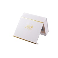 Boîte cadeau magnétique en carton imperméable en forme de livre OEM avec doublure en éponge pour parfums, crème pour les yeux, rouge à lèvres, crème pour le visage et soins de la peau