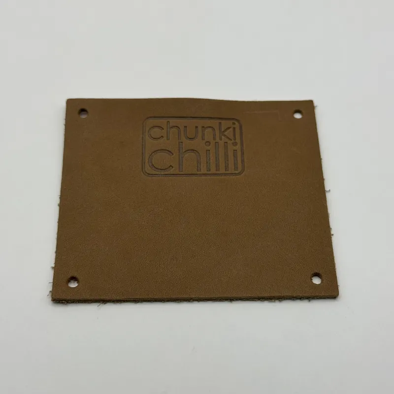 Wholesale quality custom debossed brand name logo PU leather labels patches for Jeans clothing Leather Label tags with hole