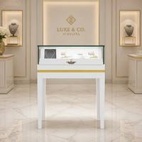 Comptoir de présentation de bijoux blanc avec dessus en verre à rayures dorées, vitrine à bijoux avec tiroir de rangement pour boutique de bijoux de luxe