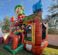 Château gonflable commercial de Noël avec toboggan, thème Père Noël, pour location événementielle