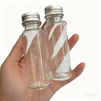 Botella de jugo de vidrio transparente vacía de 50ml con rosca continua Anillo de tapón de rosca de agua Botellas de disparos de molinillo de vidrio redondo largo y delgado