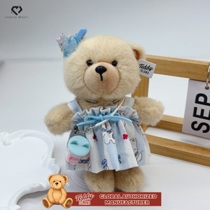 Teddy ISLAND Giocattolo di Peluche Carino con Autorizzazione Globale, Gonna Floreale Bianca, Accessori con Fiocco e Cordino Blu - Product Image 2