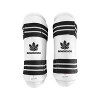 Protège-tibias de Taekwondo en mousse PU avec sangle élastique réglable pour l'entraînement et le sparring, personnalisables avec logo pour clubs et dojos, commande en gros