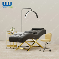 Union Win Nouveau design Table de massage pour salon de beauté Lit à cils incurvé en cuir rose avec base en métal doré Lit de massage pour cils de luxe