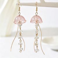 Boucles d'oreilles tendance en perles de verre oniriques avec créatures marines fluides et motifs pastèque