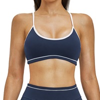 Soutien-gorge de sport pour femme avec bretelles réglables et rembourrage, dos croisé et bordure contrastante, idéal pour le yoga et le fitness