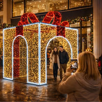 Tunnel lumineux géant LED en forme de boîte cadeau de Noël pour décoration extérieure de centres commerciaux, places publiques et points photo