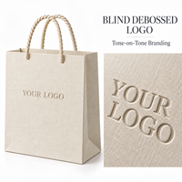 Sac en papier ivoire de qualité supérieure avec logo personnalisé, sac d'emballage pour bijoux en papier texturé, sac de boutique avec poignée en corde torsadée